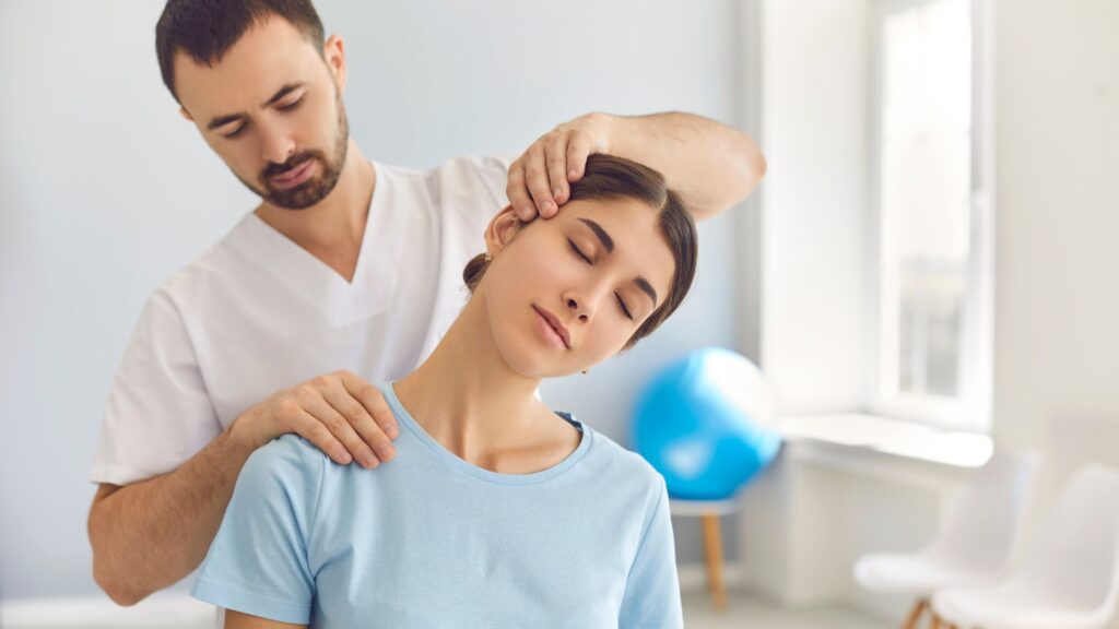 A Professional Chiropractic Doing Neck Adjustment of A Female Patient in His Modern Clinic